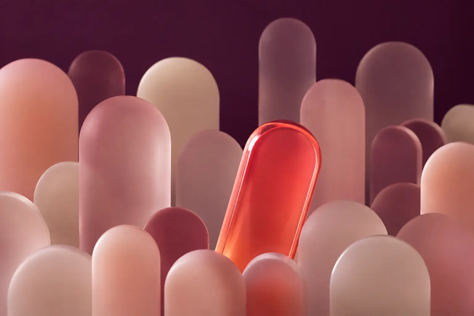 One vivid coral form standing out within a field of muted forms